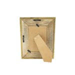 Wooden picture frame with a cardboard backing on a white background