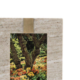 Framed photograph of a garden with trees and colorful flowers on a textured beige background