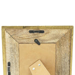 Back of a wooden picture frame with a cardboard backing and metal hardware.