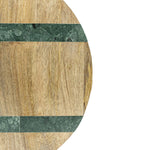 Round wooden cutting board with green marble inlay on a white background
