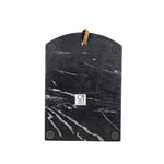 Black marble cutting board with brown handle on a white background