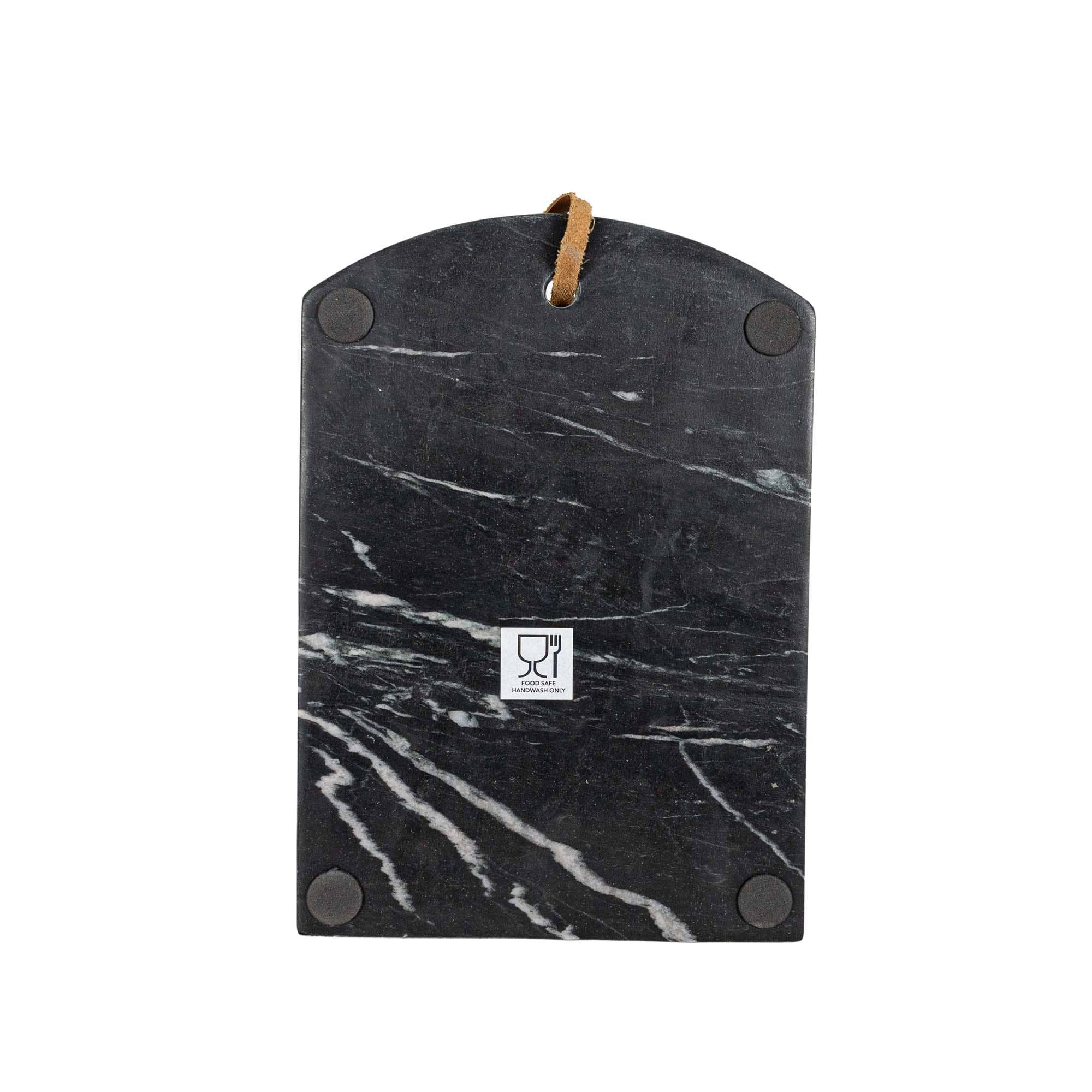 Black marble cutting board with brown handle on a white background