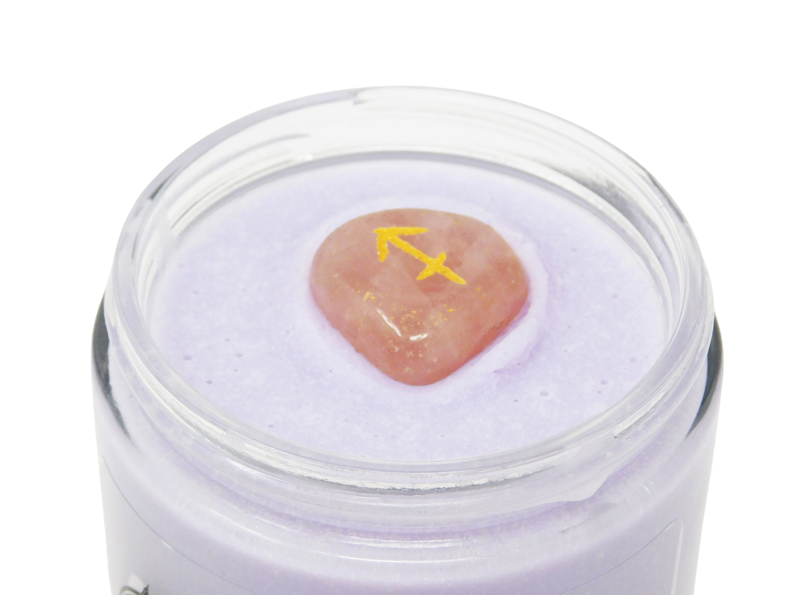 Jar of purple cream with a pink stone and yellow arrow symbol on a white background