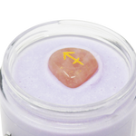 Jar of purple cream with a pink stone and yellow arrow symbol on a white background