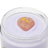 Jar of purple cream with a pink stone and yellow arrow symbol on a white background