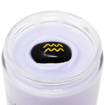 Astrology body cream with a black stone featuring a yellow logo on a black background