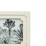 Framed black and white landscape print of desert scene with Joshua trees.