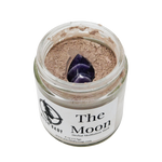 Jar of 'The Moon' herbal meditation ash with a purple crystal on a white background