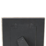 Back view of a picture frame with mounting hardware on a white background