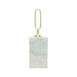 Marble-textured rectangular object with gold clip on a white background