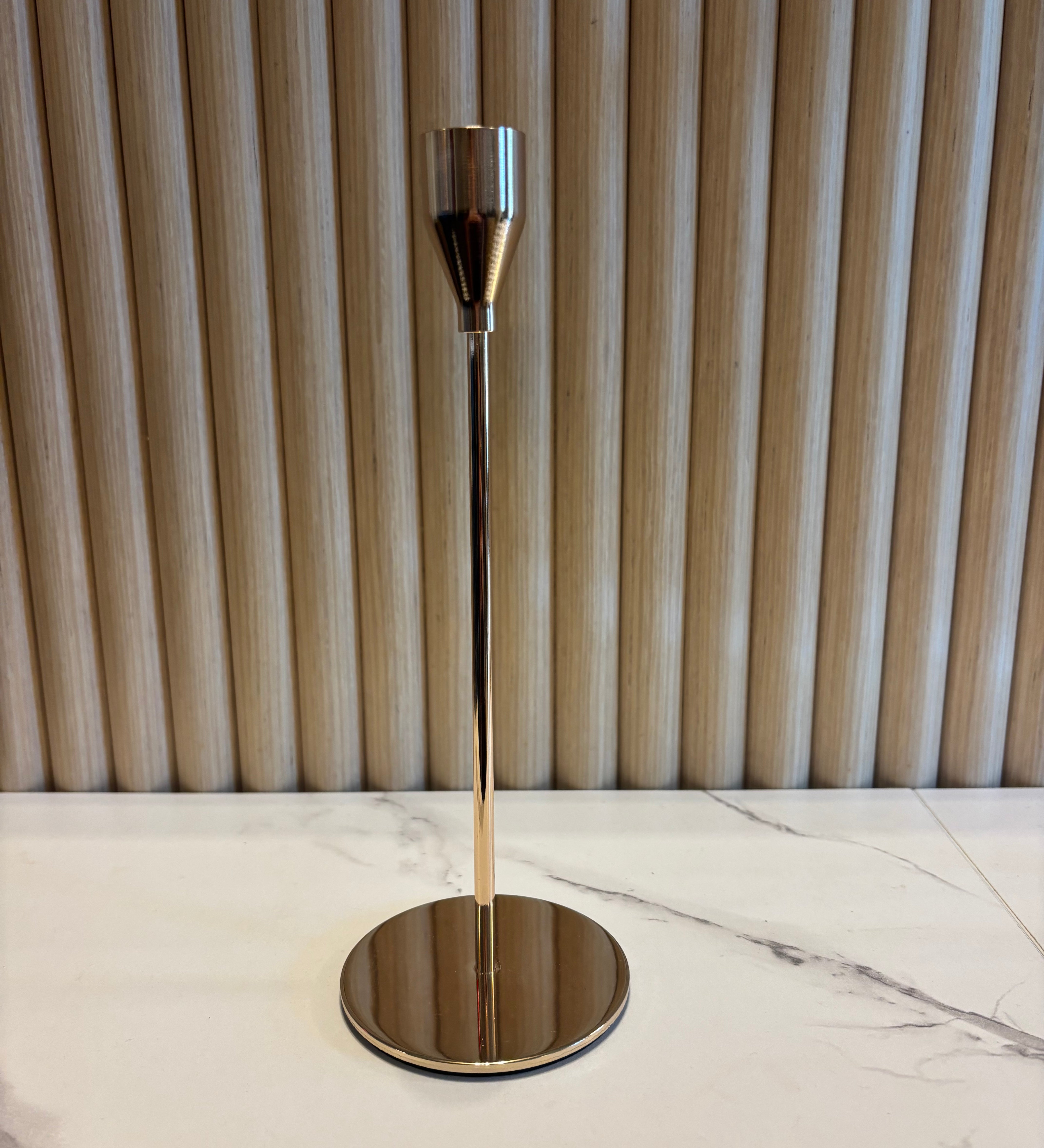 Small Gold Taper Candle Holder with a metallic finish on a marble surface