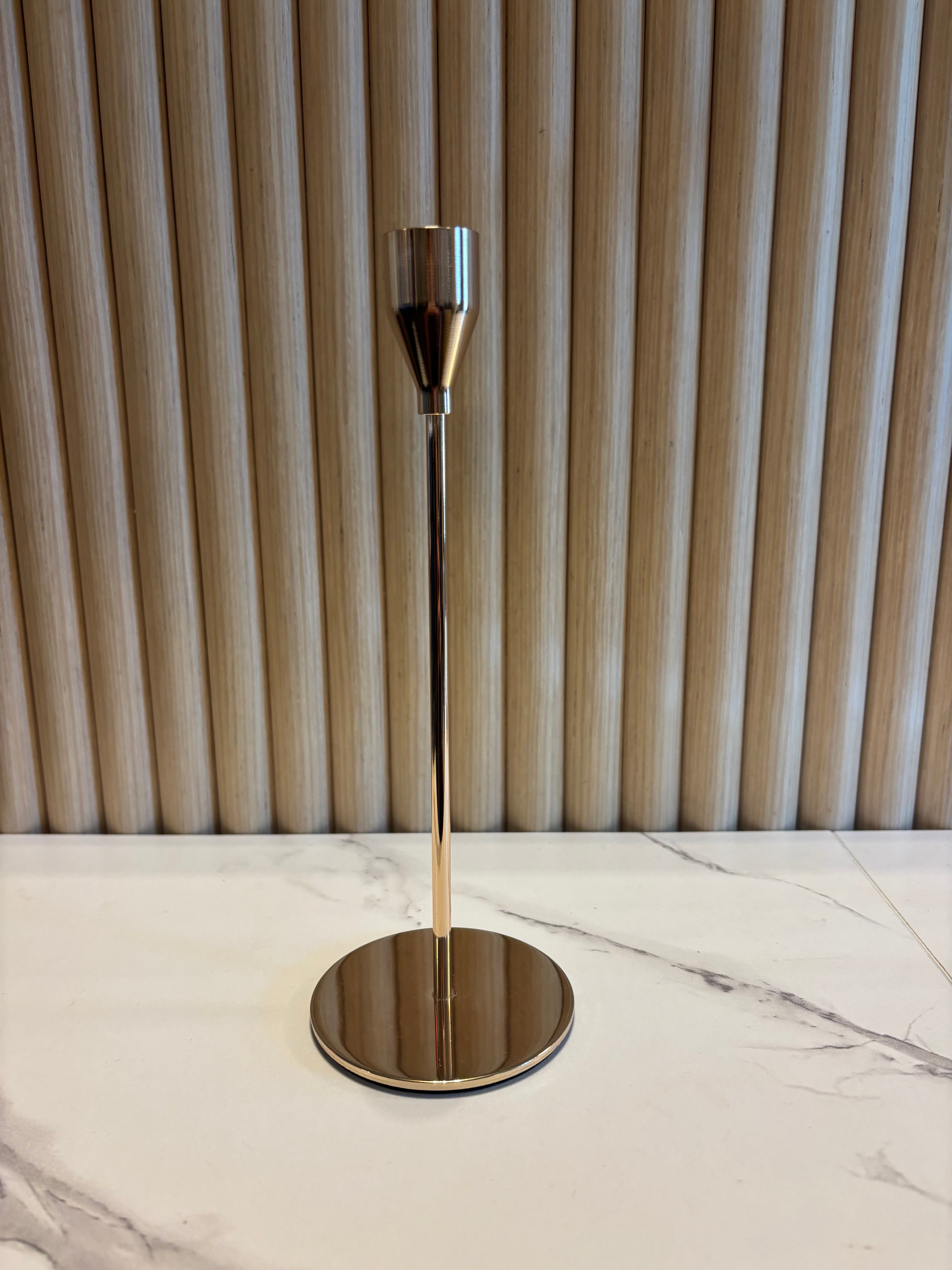 Small Gold Taper Candle Holder with a metallic finish on a marble surface