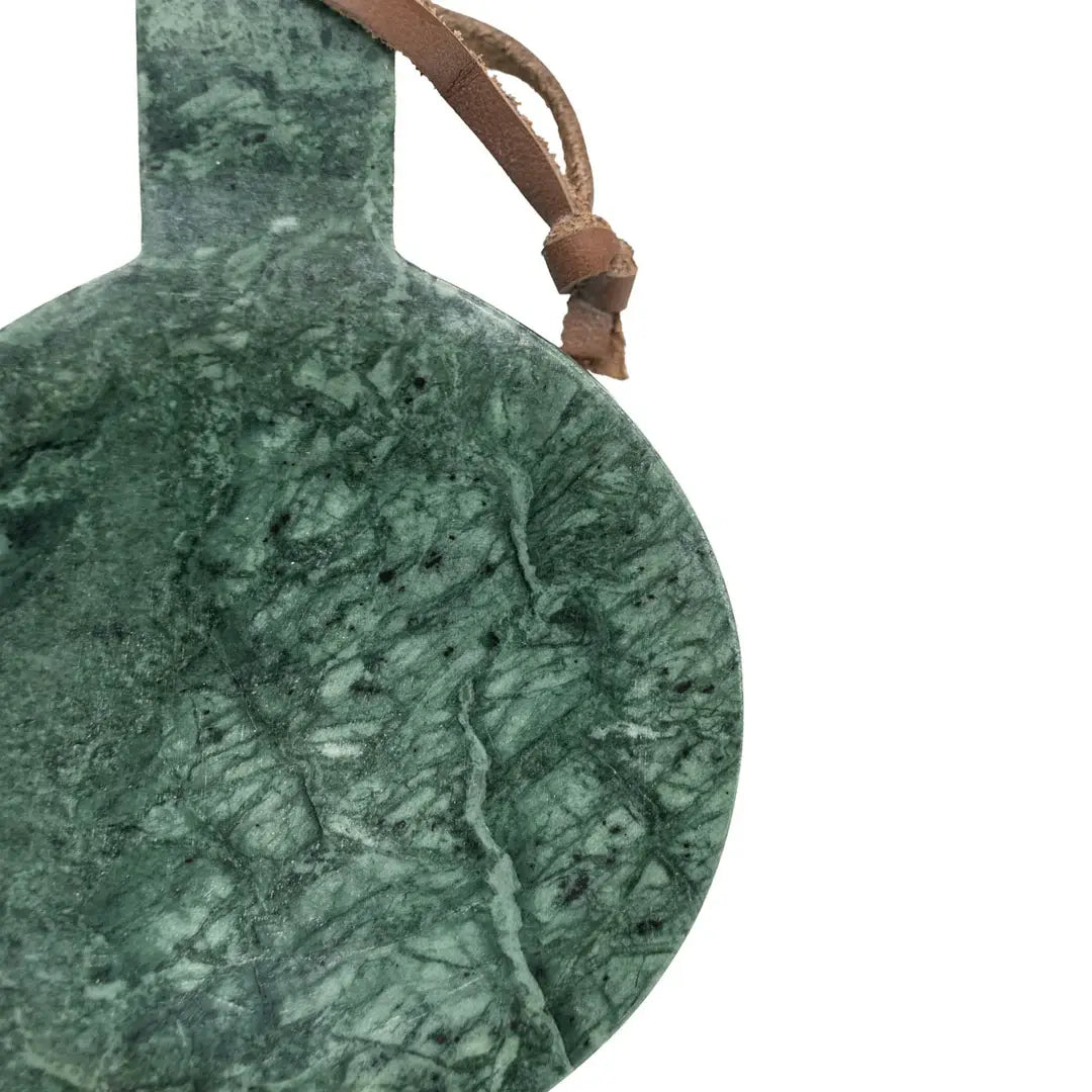 Green marble ornament with a brown leather strap on a white background