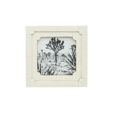 White picture frame with a black and white nature scene inside on a white background