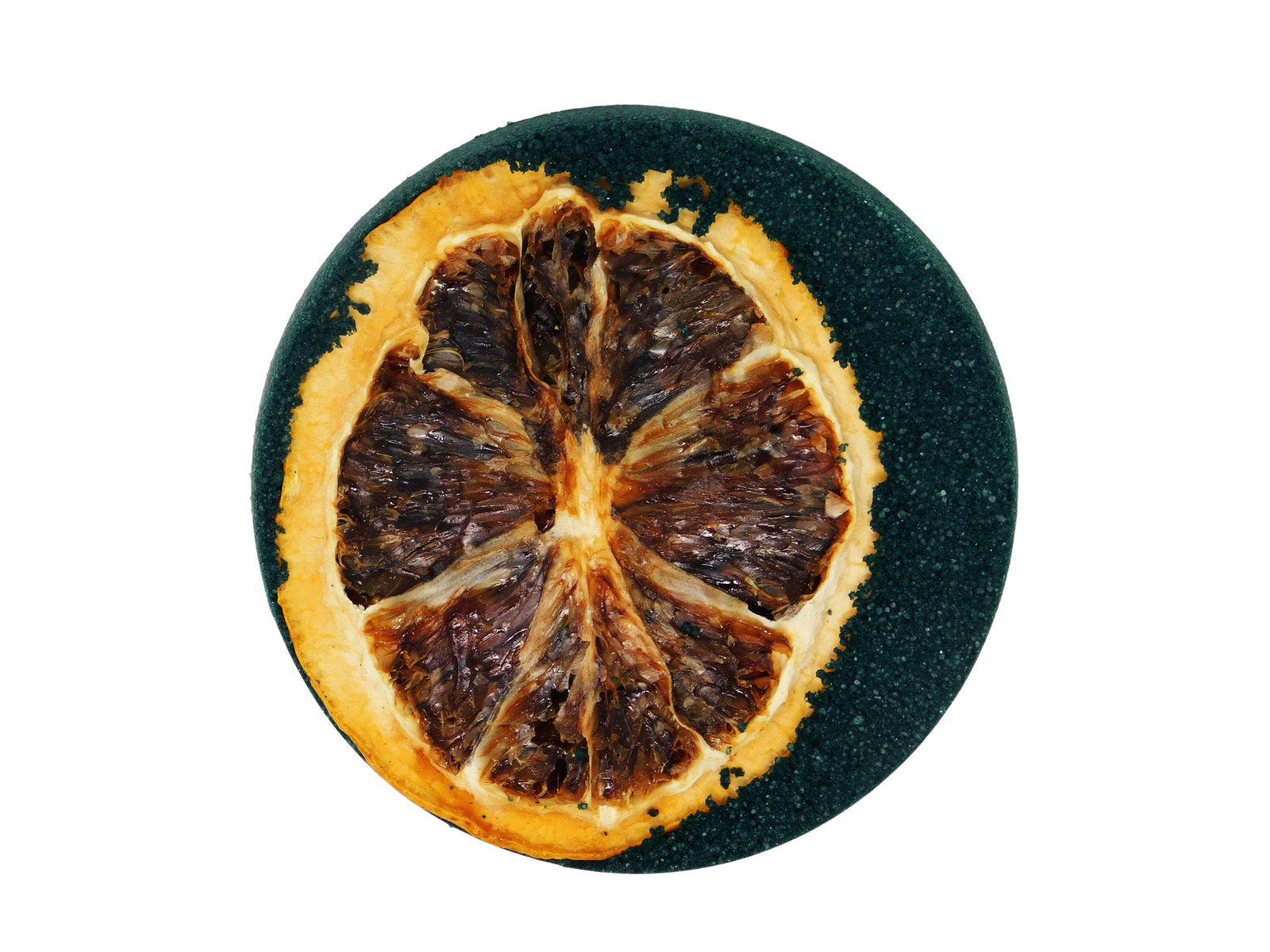 Dried orange slice on a black round surface